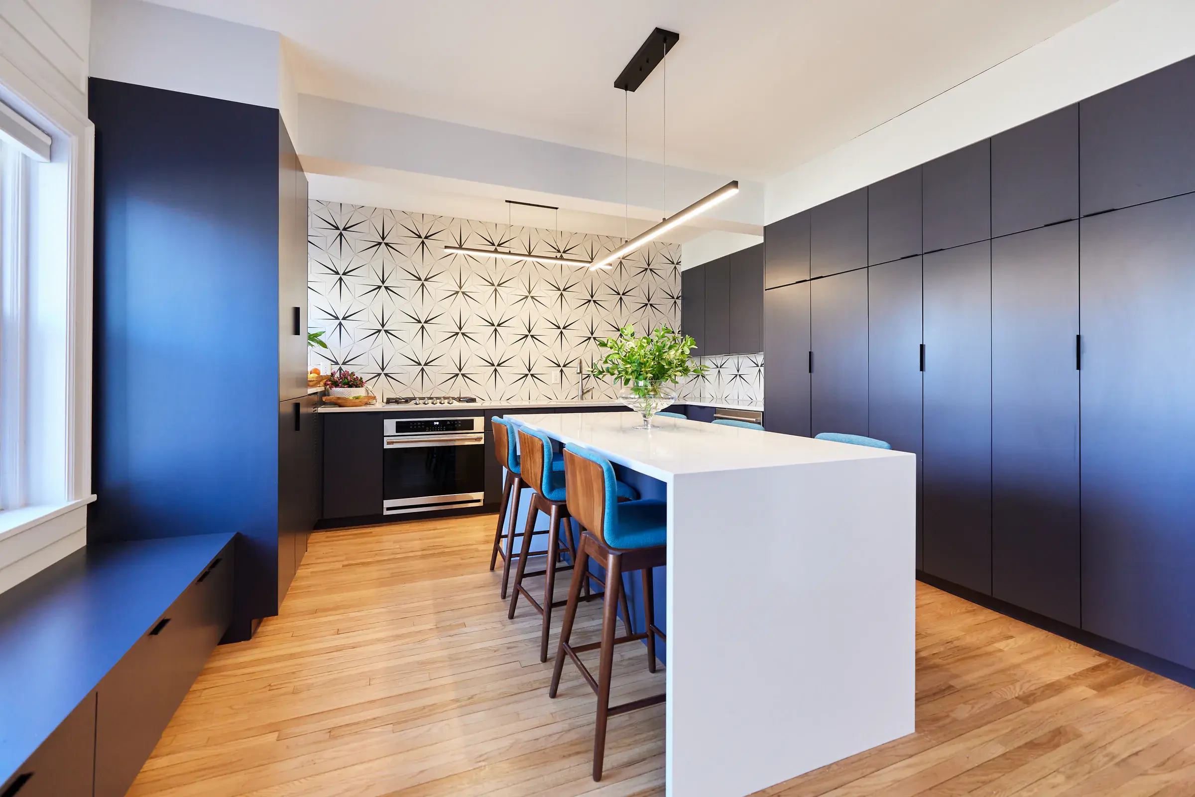 Natural hardwood floor installation in a modern apartment kitchen