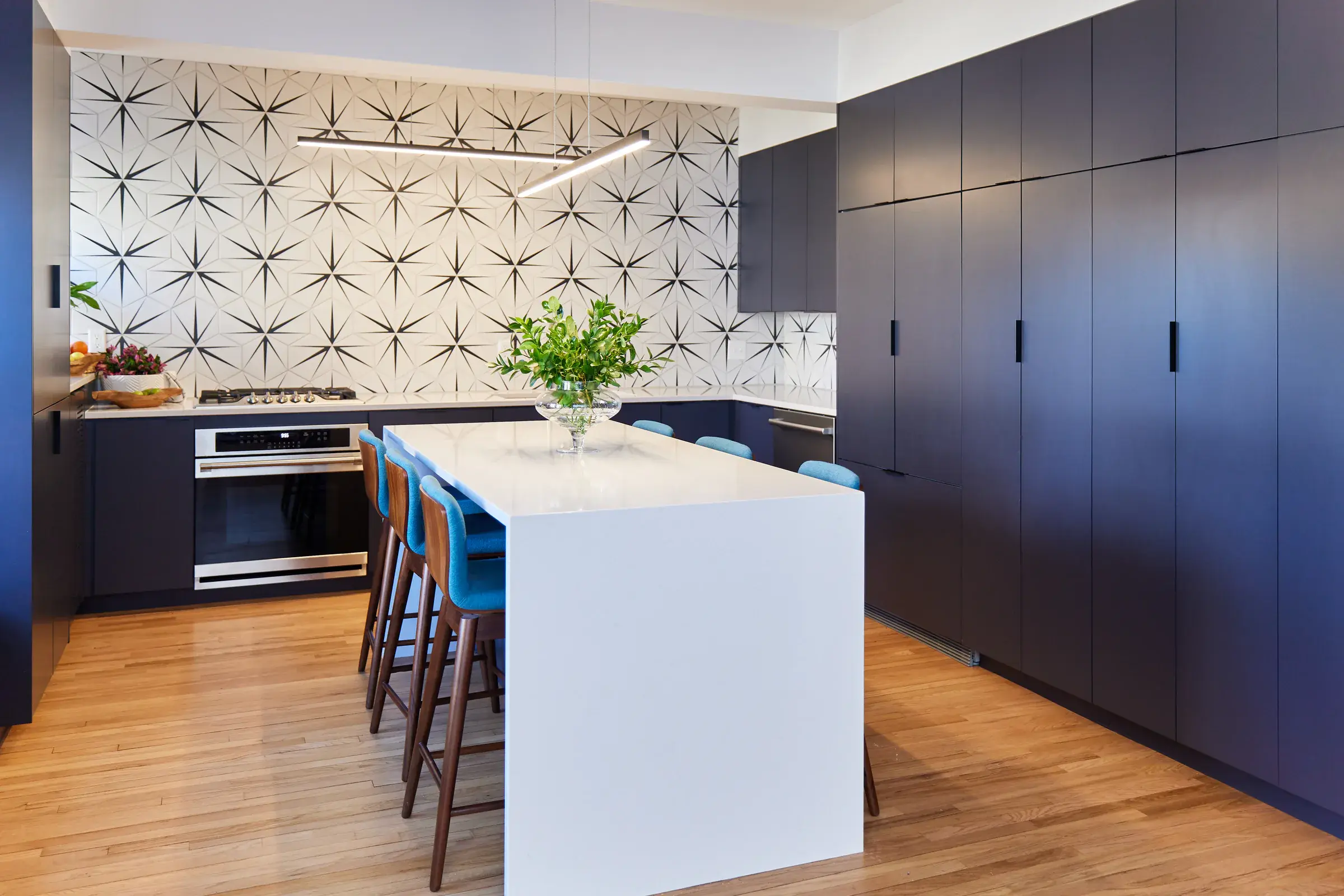 Finished hardwood floor in a modern apartment kitchen completed by Noble Hardwoods