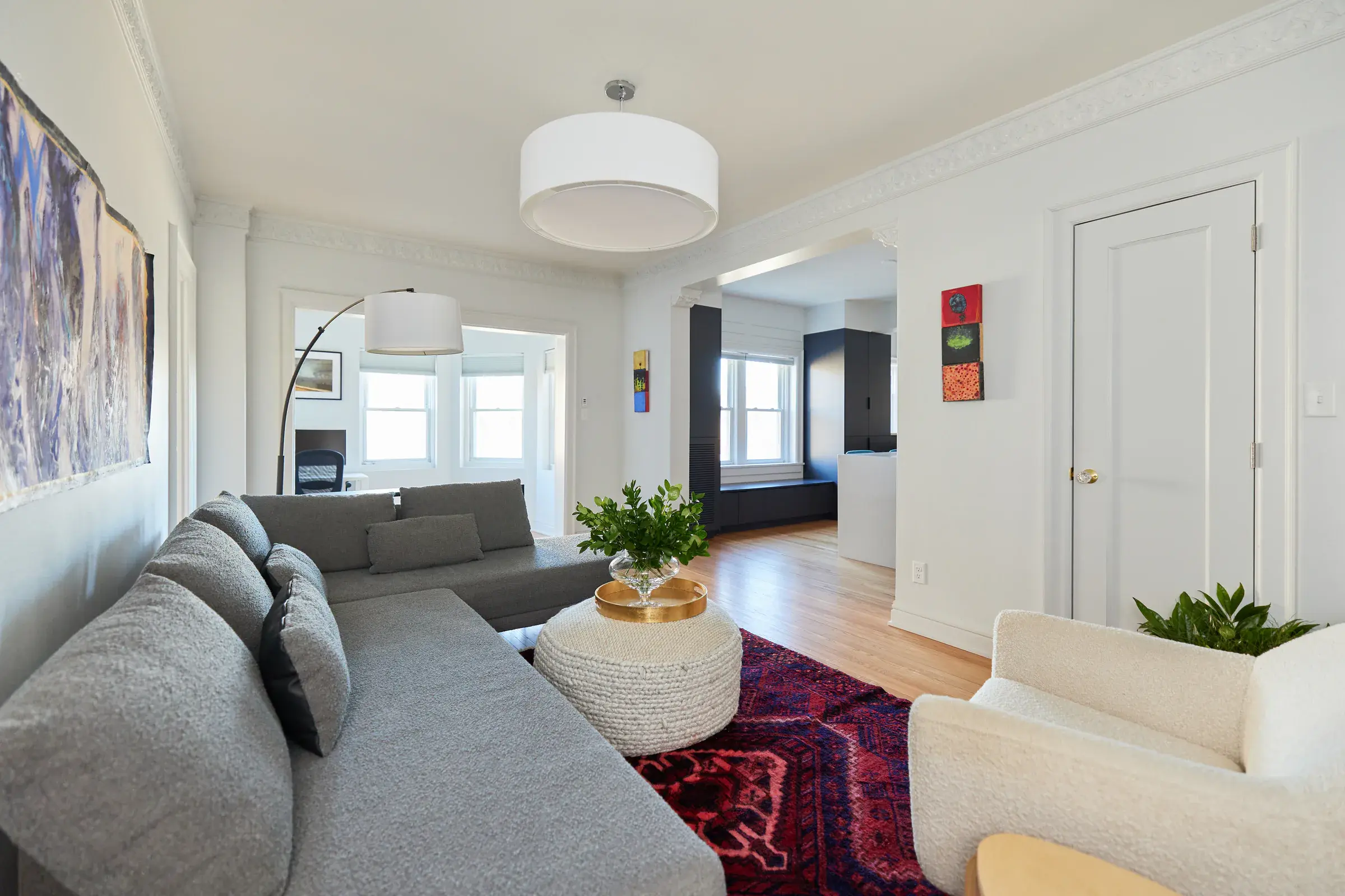 Warm hardwood flooring throughout a furnished apartment living room