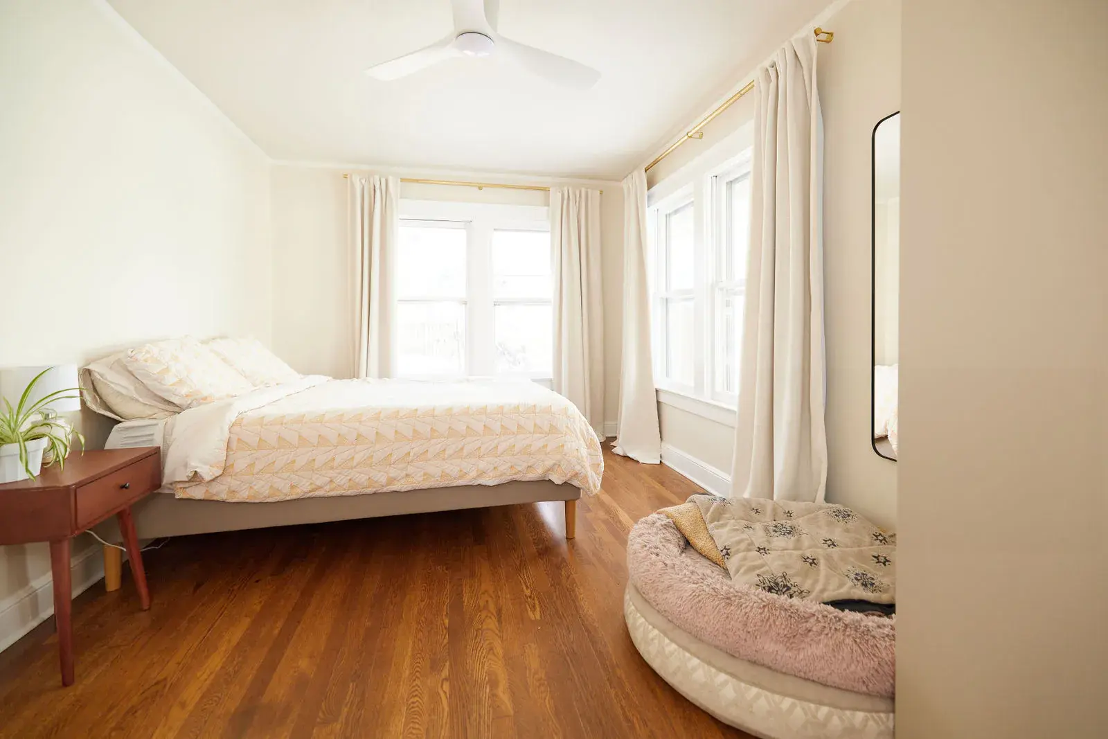 Restored hardwood flooring in a bright Robinson home bedroom