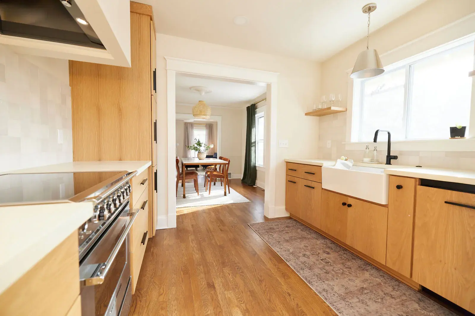 Restored hardwood floor running through a remodeled galley kitchen